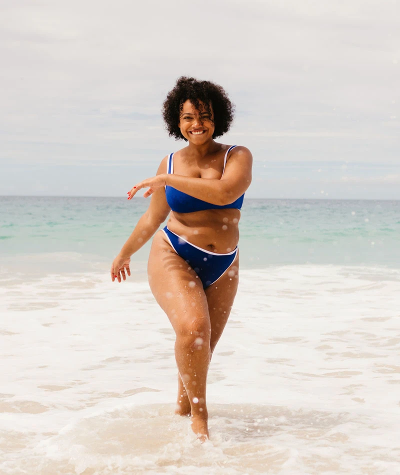 woman running on beach in bikini | Himmarshee Plastic Surgery in Fort Lauderdale