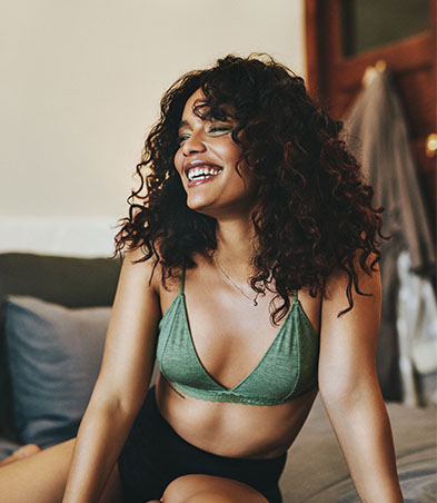 african american woman in green bra laughing